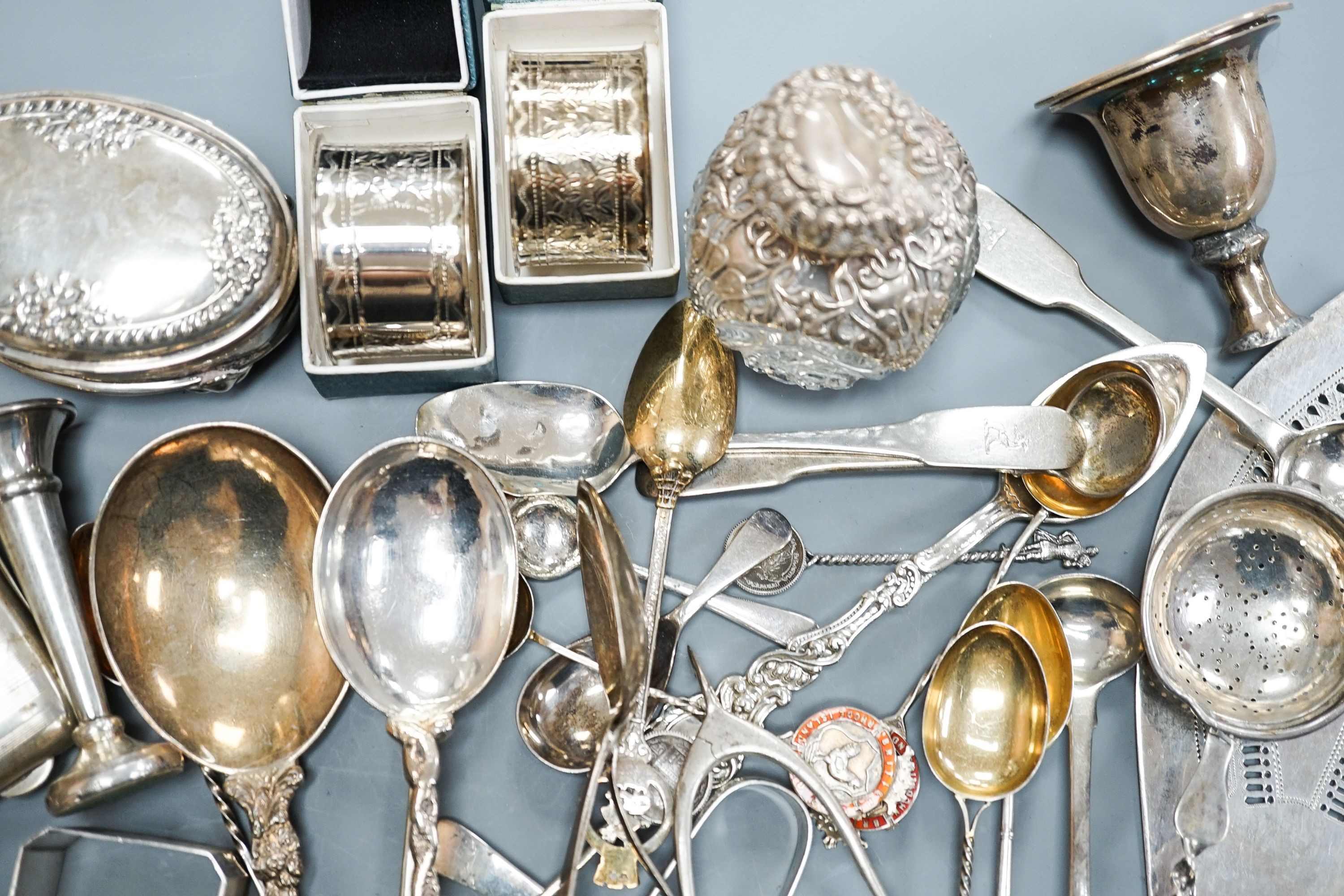A mixed collection of sundry English and other silver to include a cigarette case, wishbone sugar nips, scent bottle, mixed cutlery, napkin rings, trinket box, etc. (some a.f.) and some plated items.